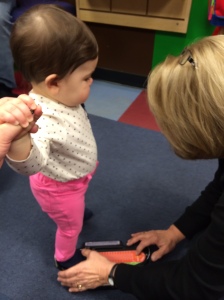 Mattelyn getting sized at Stride Rite for her first shoe fitting.